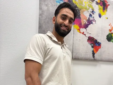 Mitarbeiter von netzwerkfähig mit Notebook vor einer Weltkarte im Büro